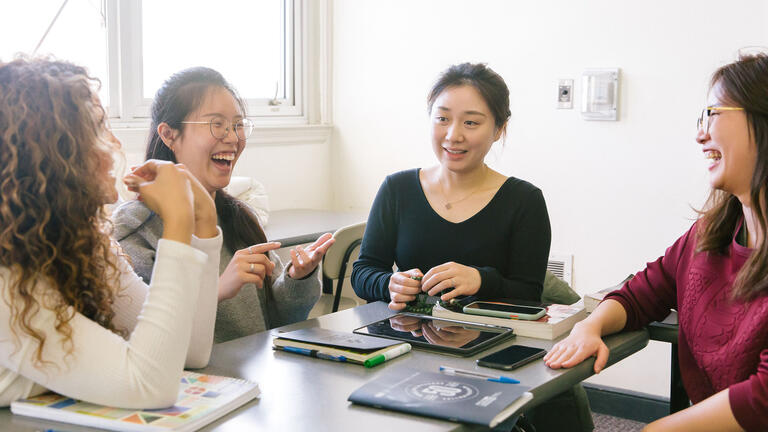 A group of students at a table having a study session.