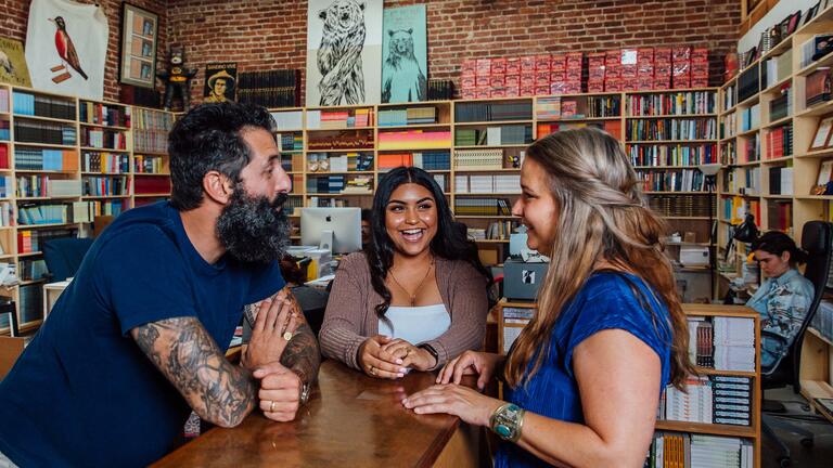 Staff and students chat in the bookstore at Dave Eggers' nonprofit 826 Valencia.