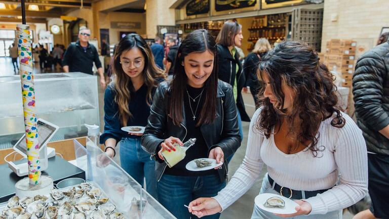 Students select oysters at a booth at the SF Ferry Building.