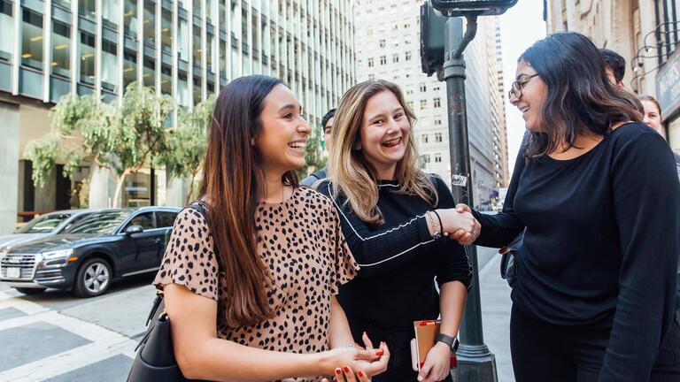 Students chat on a downtown street