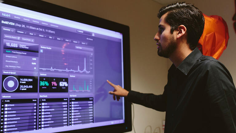 Alfonso Garcia analyzes data on a computer screen.