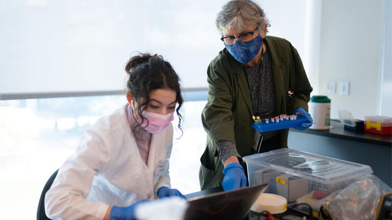 Professor helps a student in the lab.