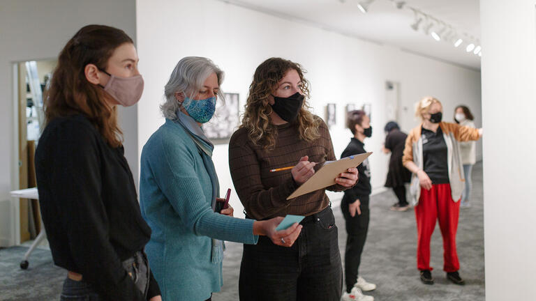 installing art exhibit in thacher gallery