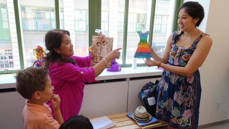 Teacher shows items to young students.