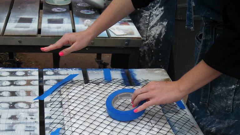 Student's hands using tape.