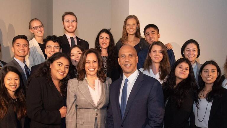 Students in a group photo with Kamala Harris and Cory Booker