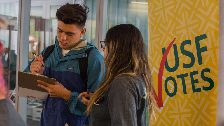 Student filling out a voter registration form
