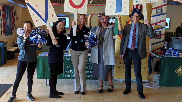 USFVote staff holding signs that say VOTE