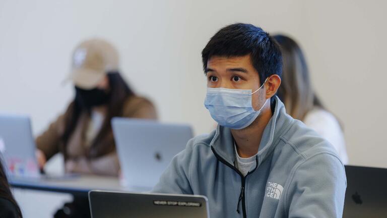 Student attentively listens in class