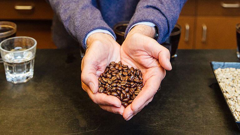 Jerry Baldwin holding coffee beans