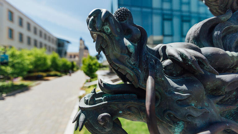 Closeup profile of a dragon statue on the lawn