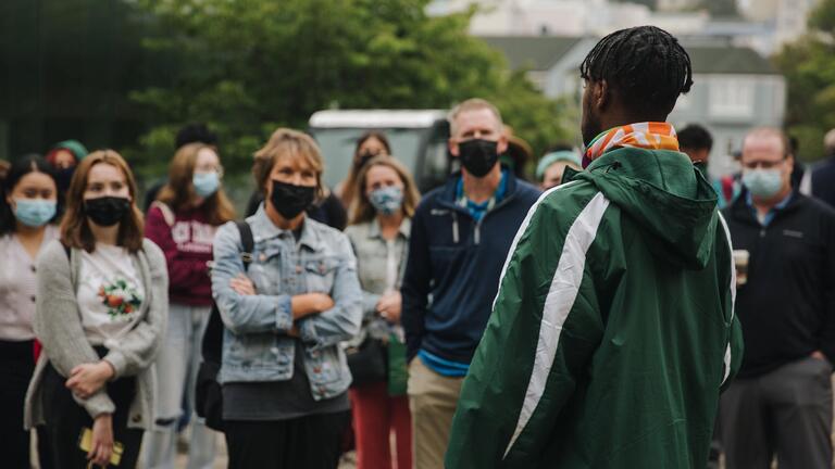 Student speaks to a gathering of parents and other students