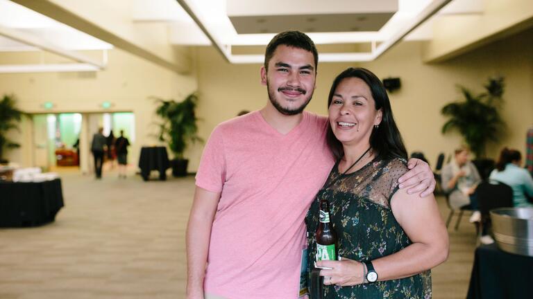 Parent stands next to college aged child