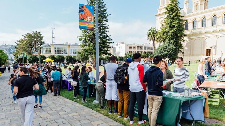Students line up in front of tables during festival