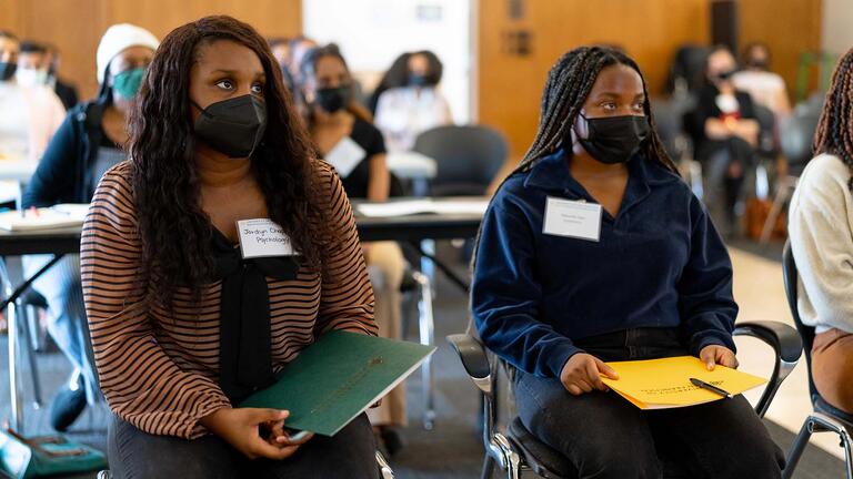 Students listen in the audience at BASE event.