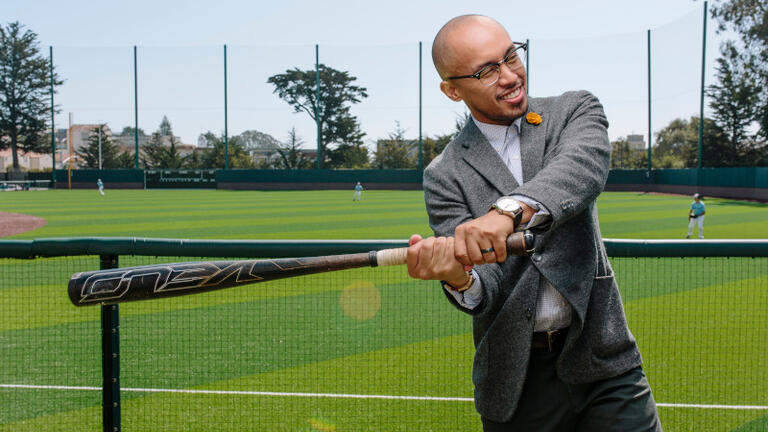 Student swinging a baseball bat