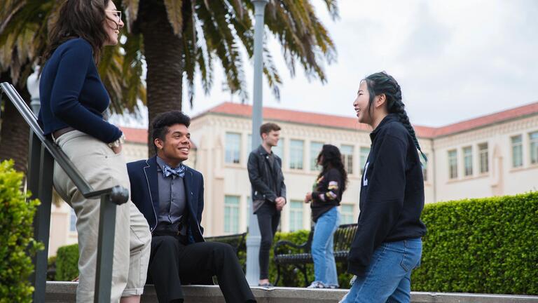 Students talking outdoors.