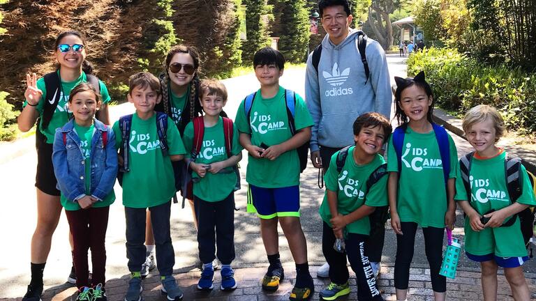 Two students leading a group of kids