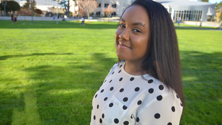 Breniel Lemley smiling for the camera in Gleeson Plaza