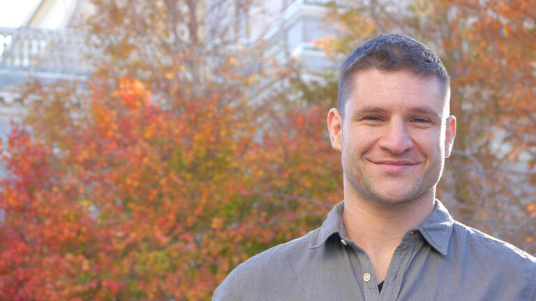 Nick Stagnaro headshot in front of autumn leaves changing colors