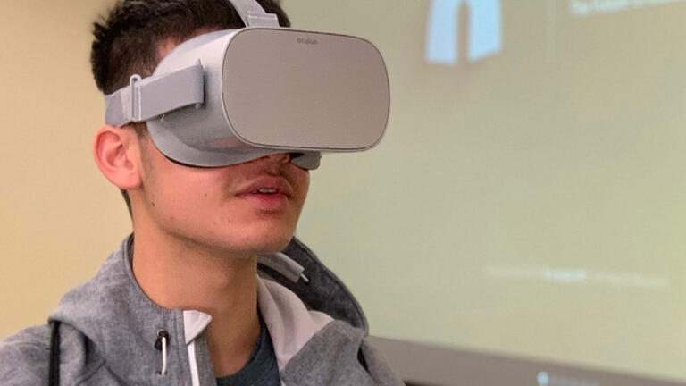 Student wearing virtual reality goggles