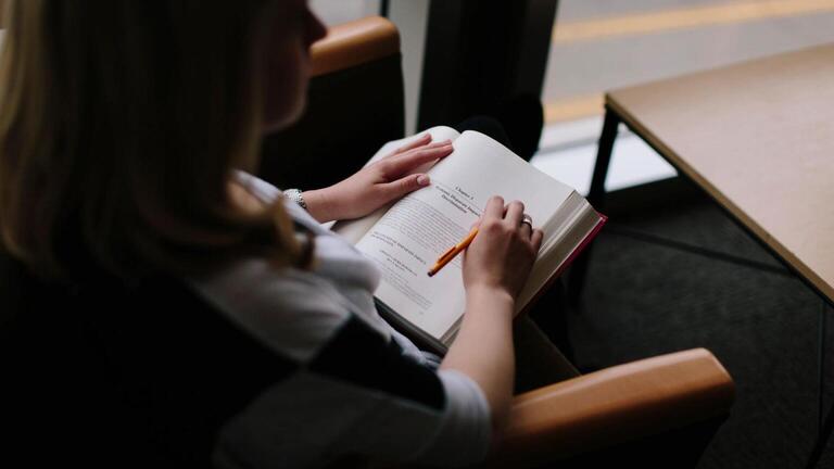 Student with open book