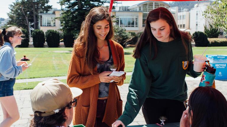 Two Students browsing at an Education Fair