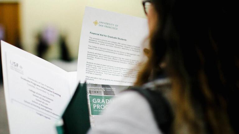 Student reviewing application material.