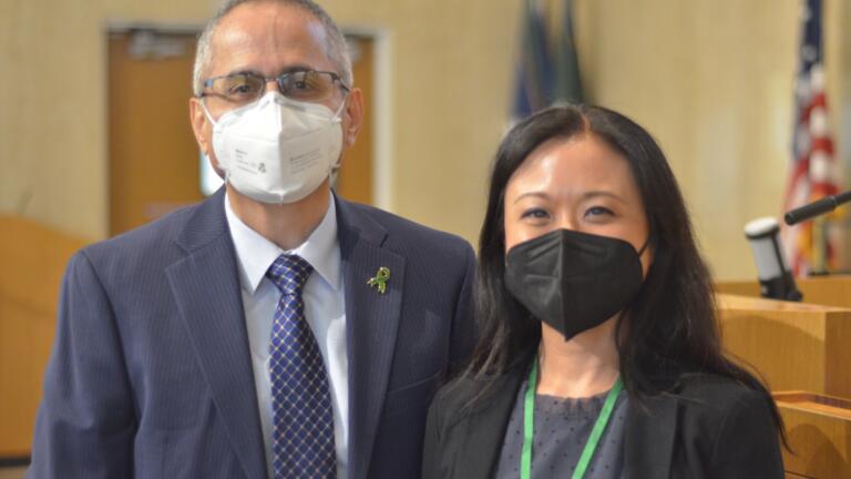 Two people wearing masks