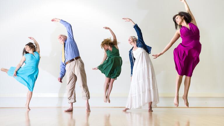 Five people of various ages dancing