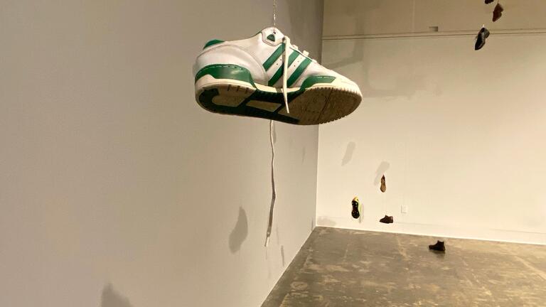 Terry Berlier, Installation view of “Waiting for the Other Shoe to…,” 2020, shoes, motors, Arduino, pulleys, ethernet cable, electronics, wood, 30’ x 15’ x 20’, photo credit: Terry Berlier, installation photo from Stanford Art Gallery