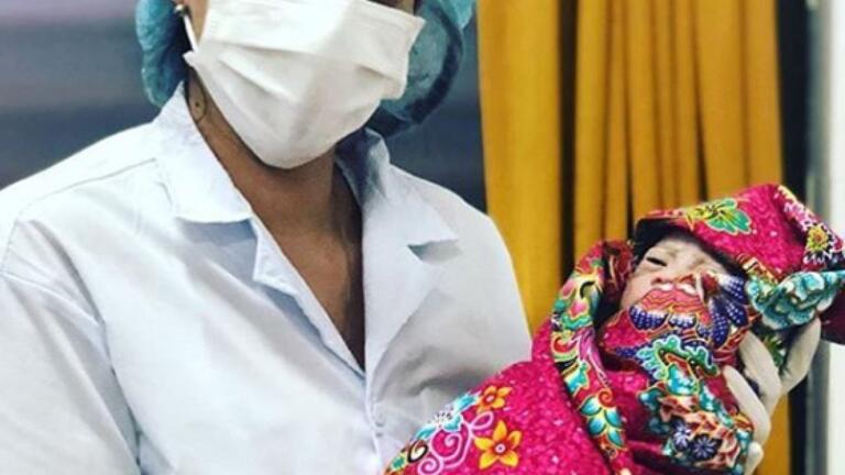 Nursing student holding a baby