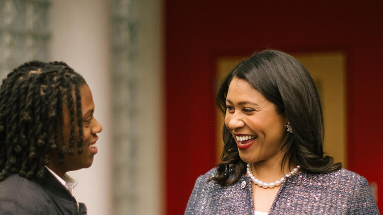 London Breed shaking hands with a citizen