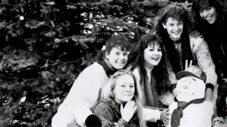 Students posing with a snowman