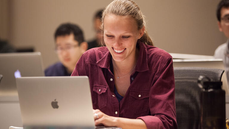 Student sitting with their laptop.