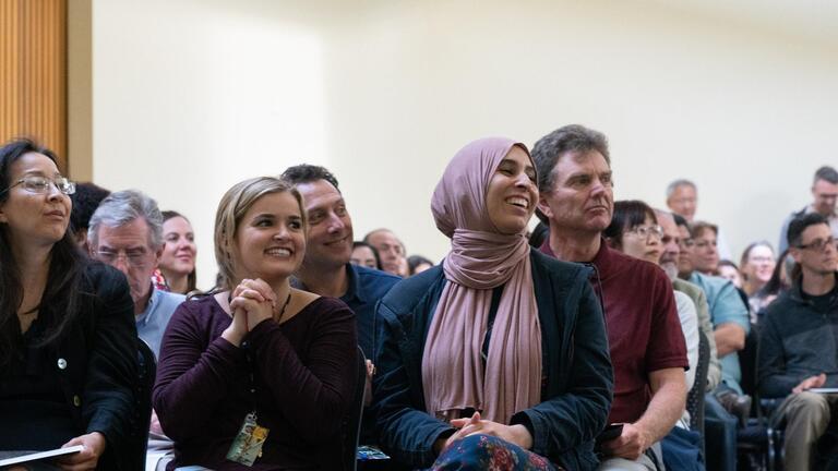 People sitting and listening to a speaker