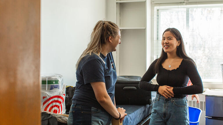 Two people in a dorm room