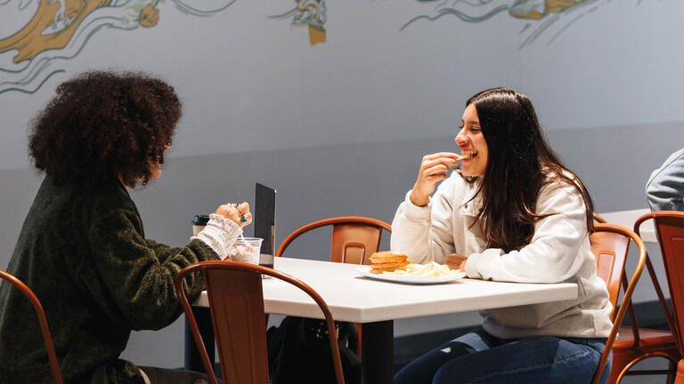 Students eating and chatting in Koret Lodge