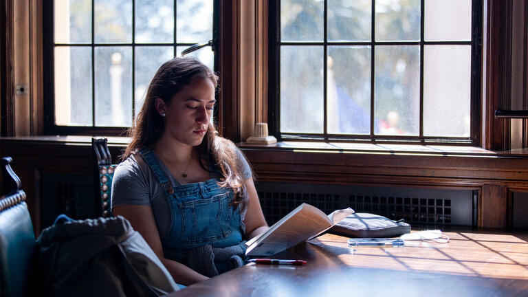 USF student reading a book