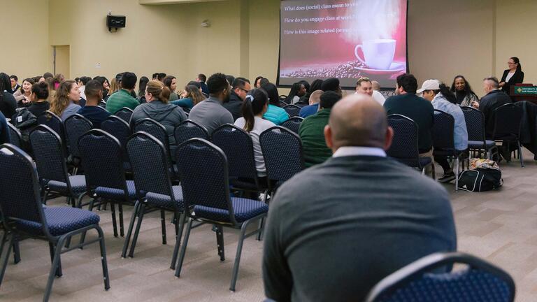 Faculty listening to a presentation.