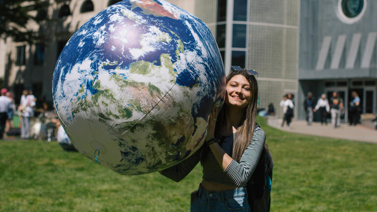 Student with large inflated globe