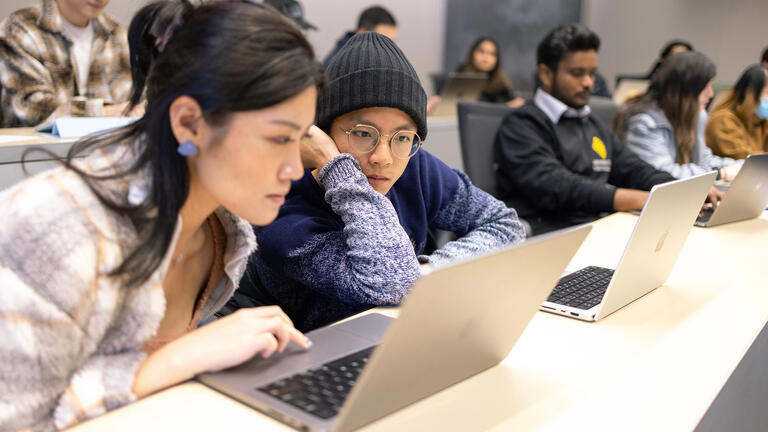 USF students working on their laptops in class