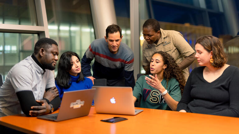 Group of students discuss a topic in class