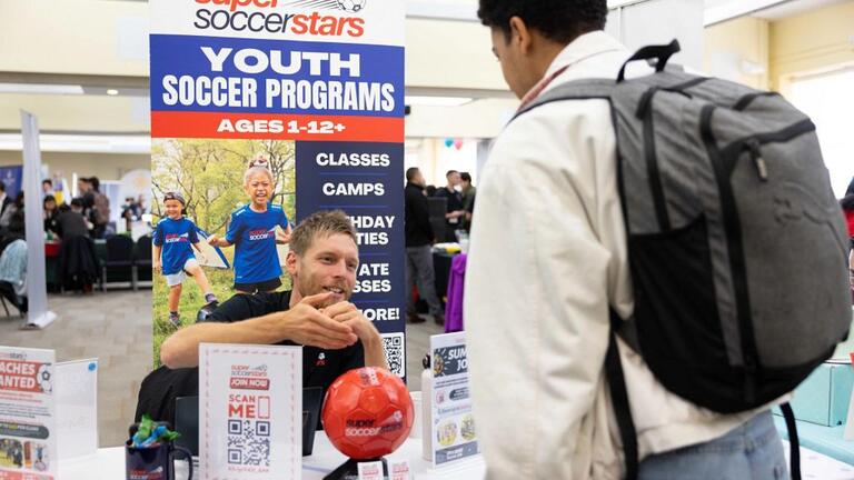 Student meeting with Super Soccer Stars rep.