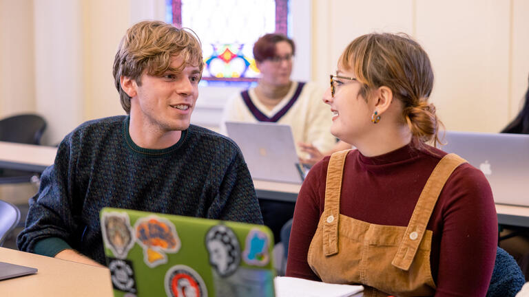 Two students talk in class