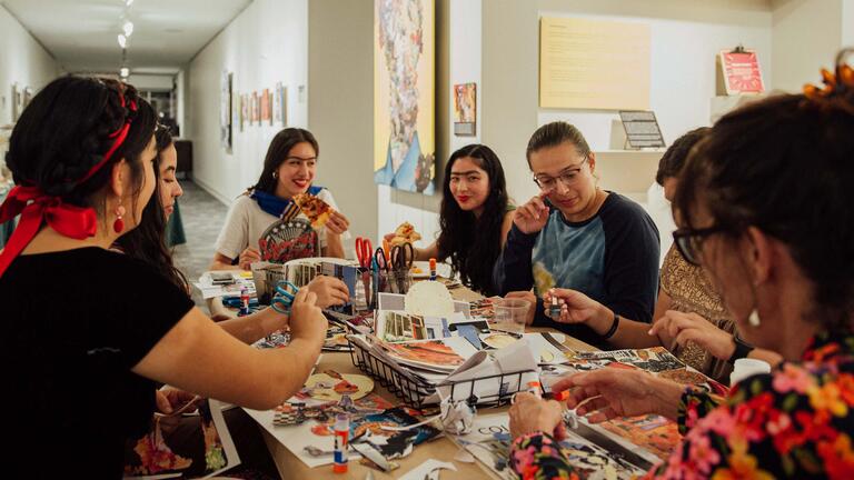 People doing crafts at a table.