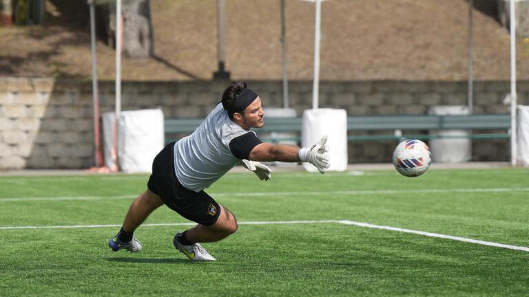 usf soccer player jumping for ball