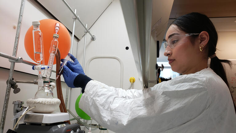 student using chemistry equipment