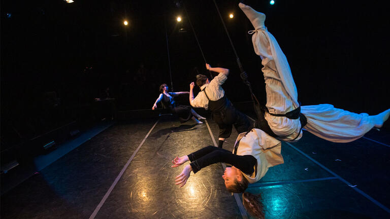 students doing acrobatics durning a dance performance in dance ensemble