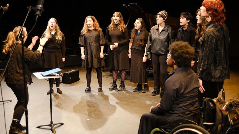 faculty conduct students in choir